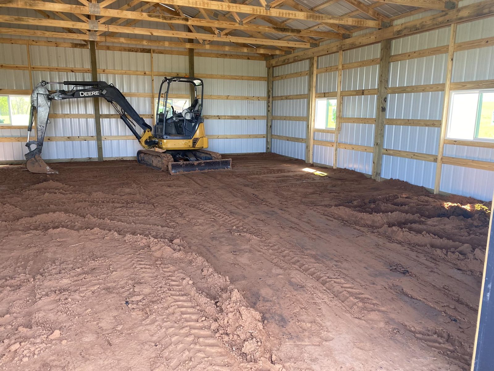 Graded dirt pad inside a metal building