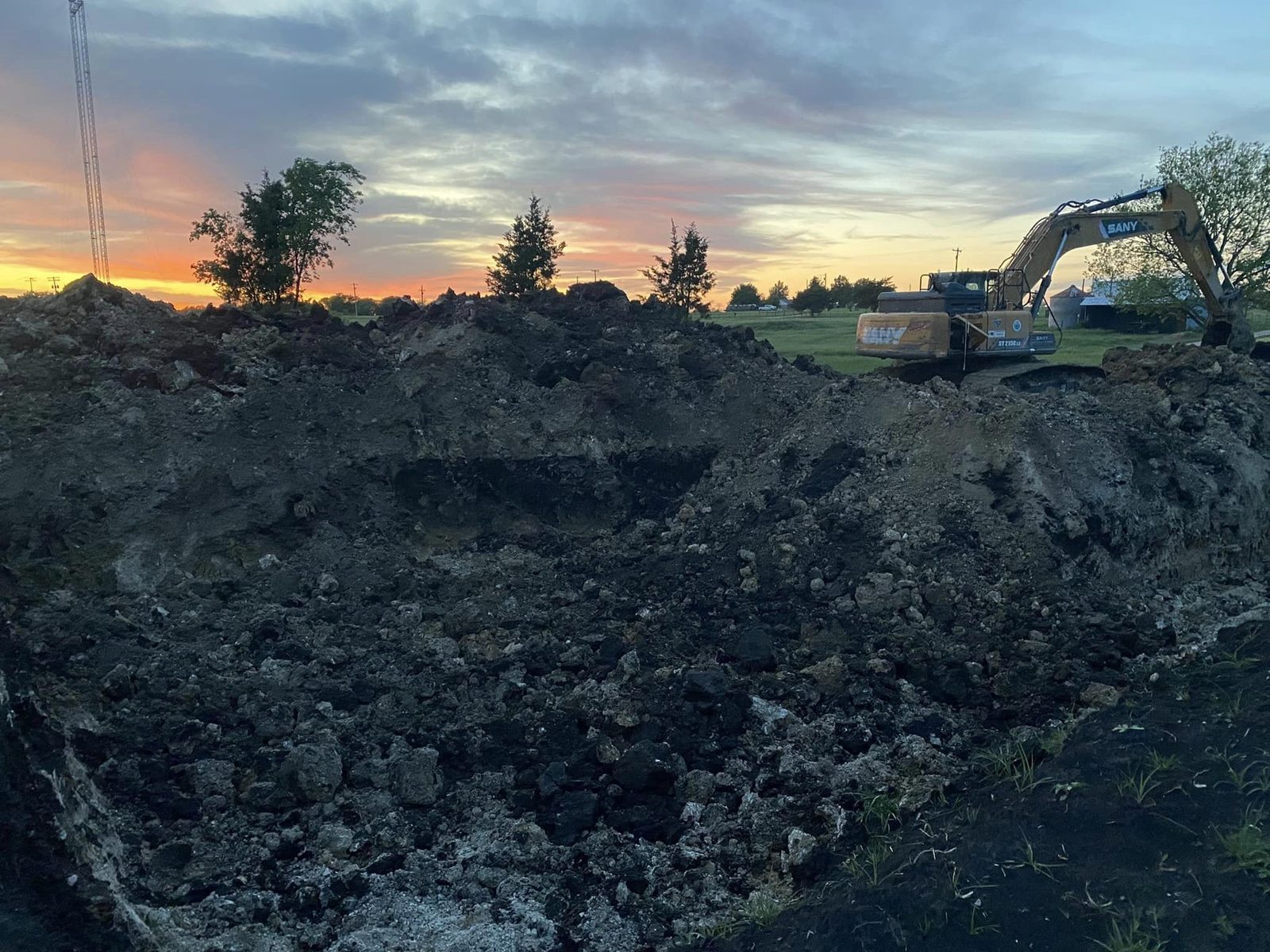 Excavation and spoil pile at sunset